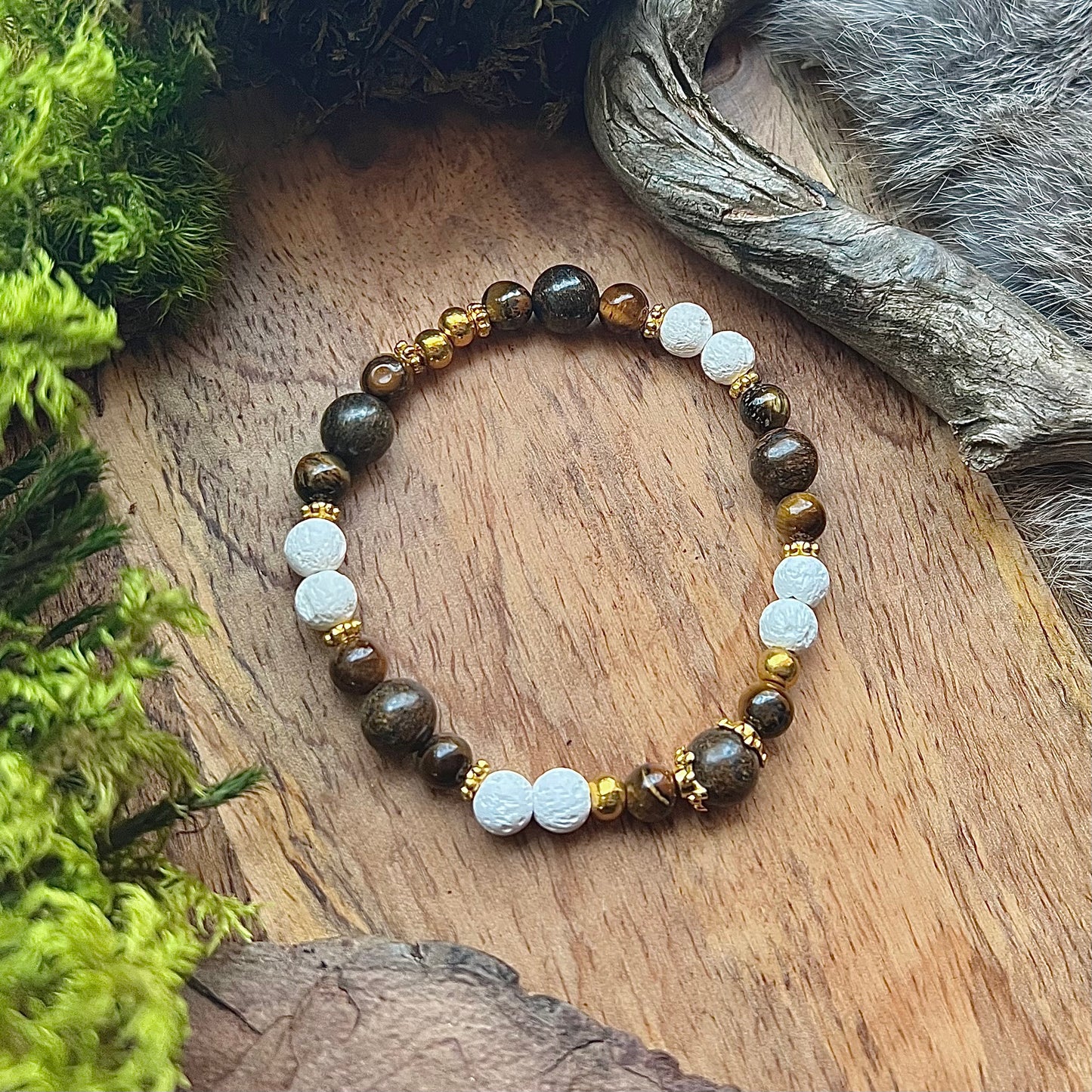 Bracelet made of crystal with tiger eye, bronzite, lava stone and brass