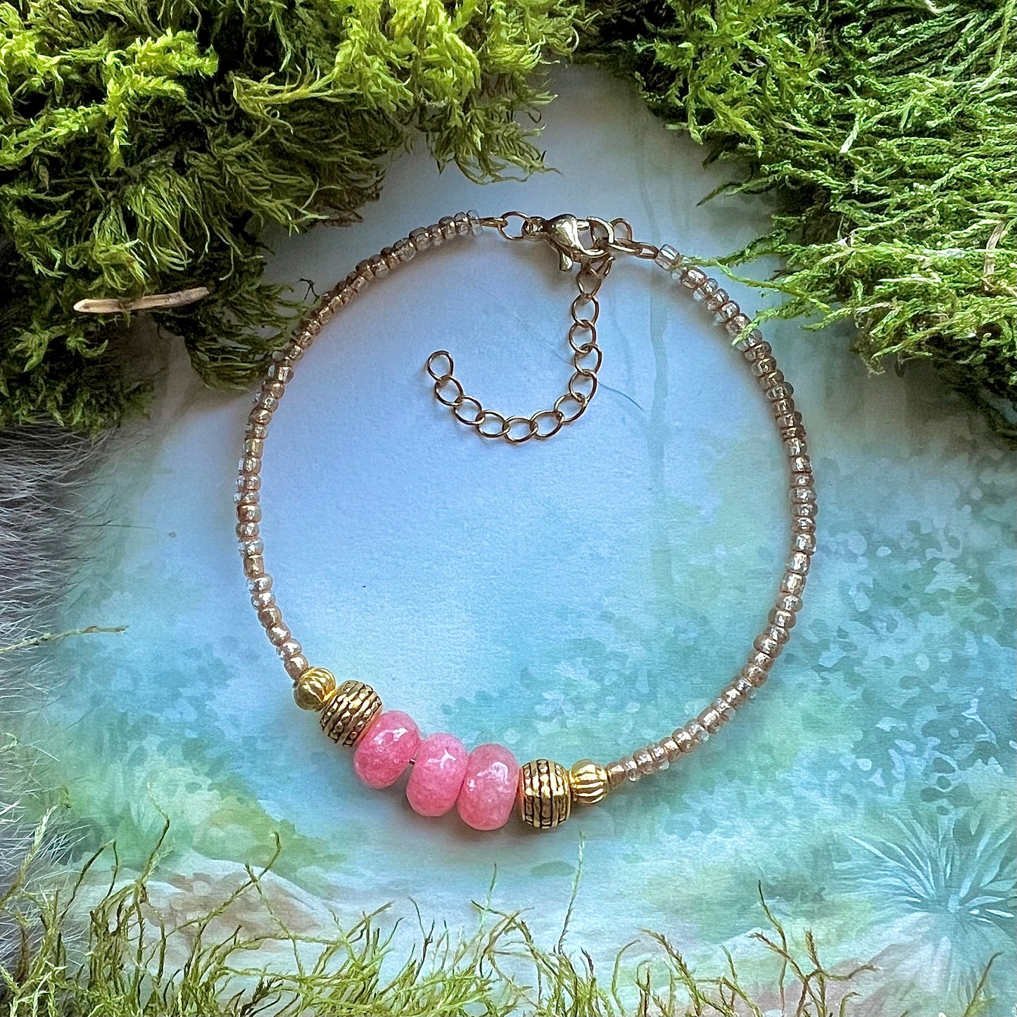 Kristallarmband med guldfärgade vikingapärlor och rosa fasetterad jade