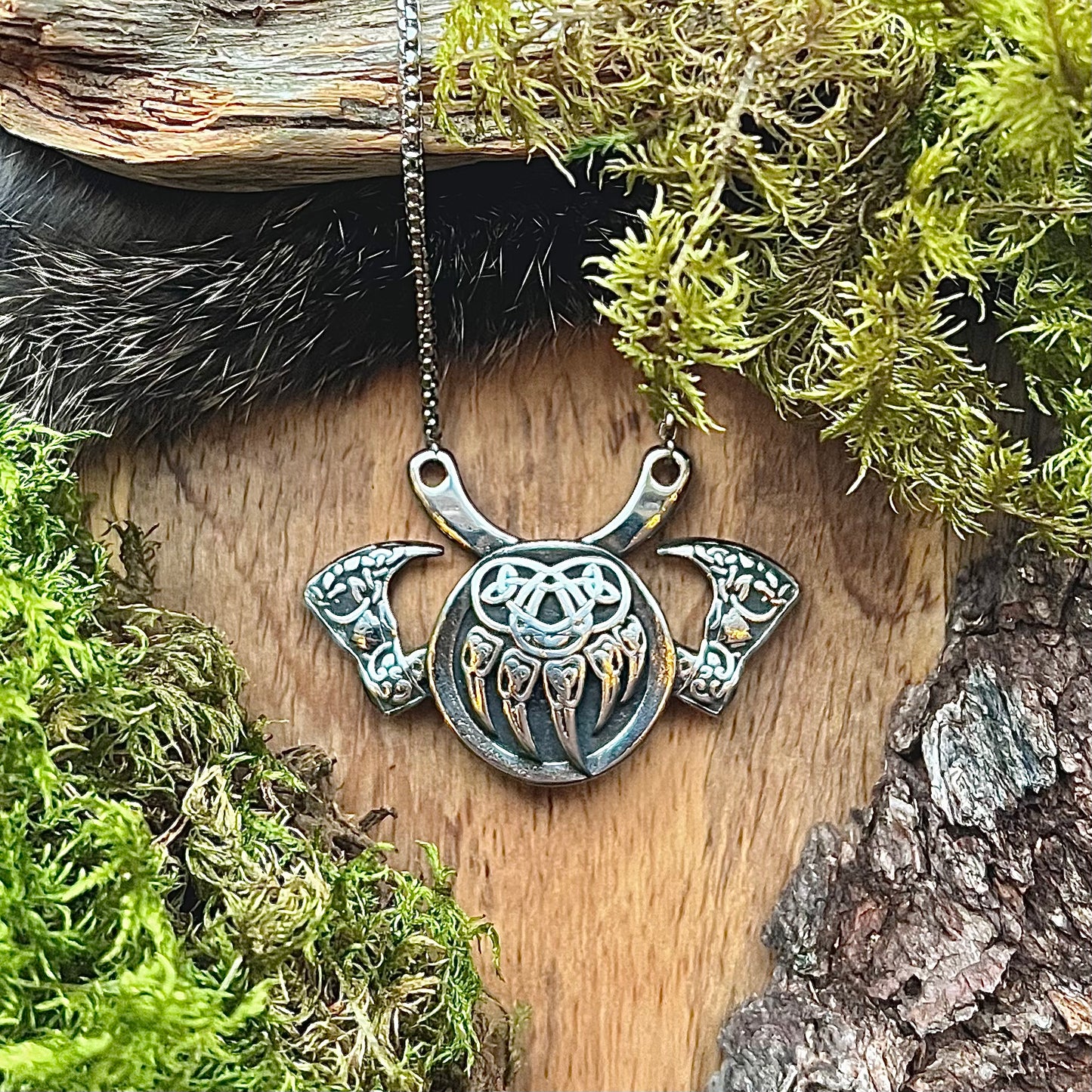 Stainless steel necklace with a bear paw and two crossed battle axes