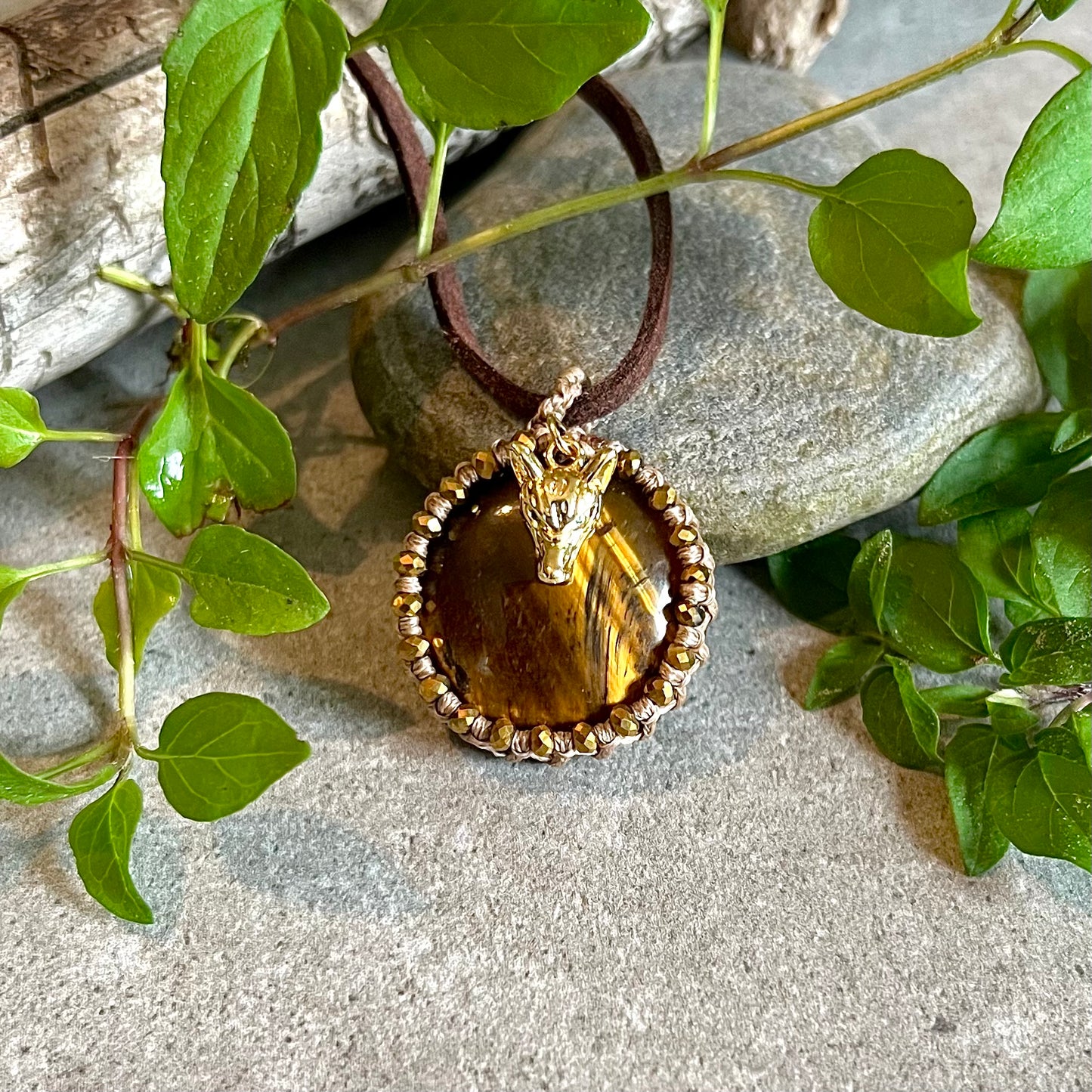 Necklace with bound tiger eye and gold-plated wolf head