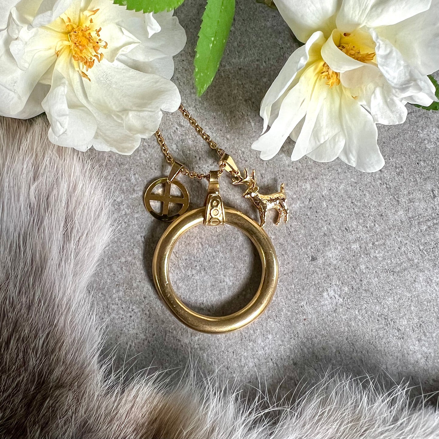 Necklace "Midnight Sun" with brass ring, solar cross and gold-plated reindeer
