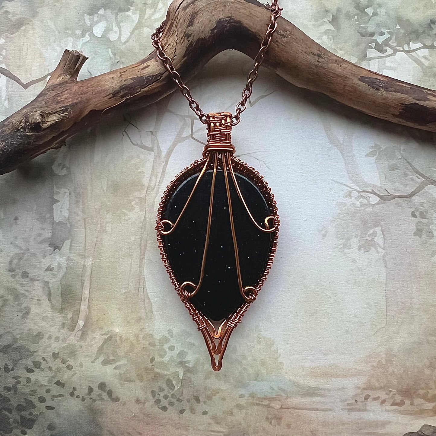 Necklace with drop-shaped blue gold stone and copper wire