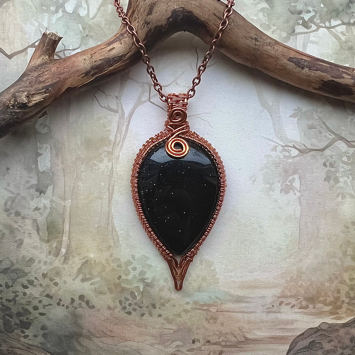 Necklace with drop-shaped blue gold stone and copper wire