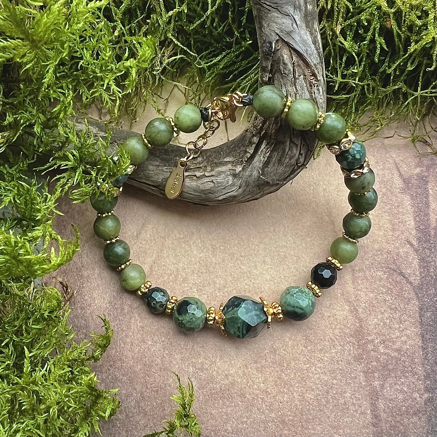 Bracelet "Mother Earth" made of green jade and kambaja stove with gold-colored brass details