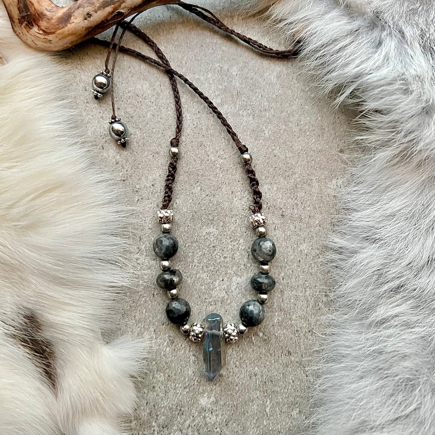 Hand-knotted necklace with faceted labradorite and quartz tip