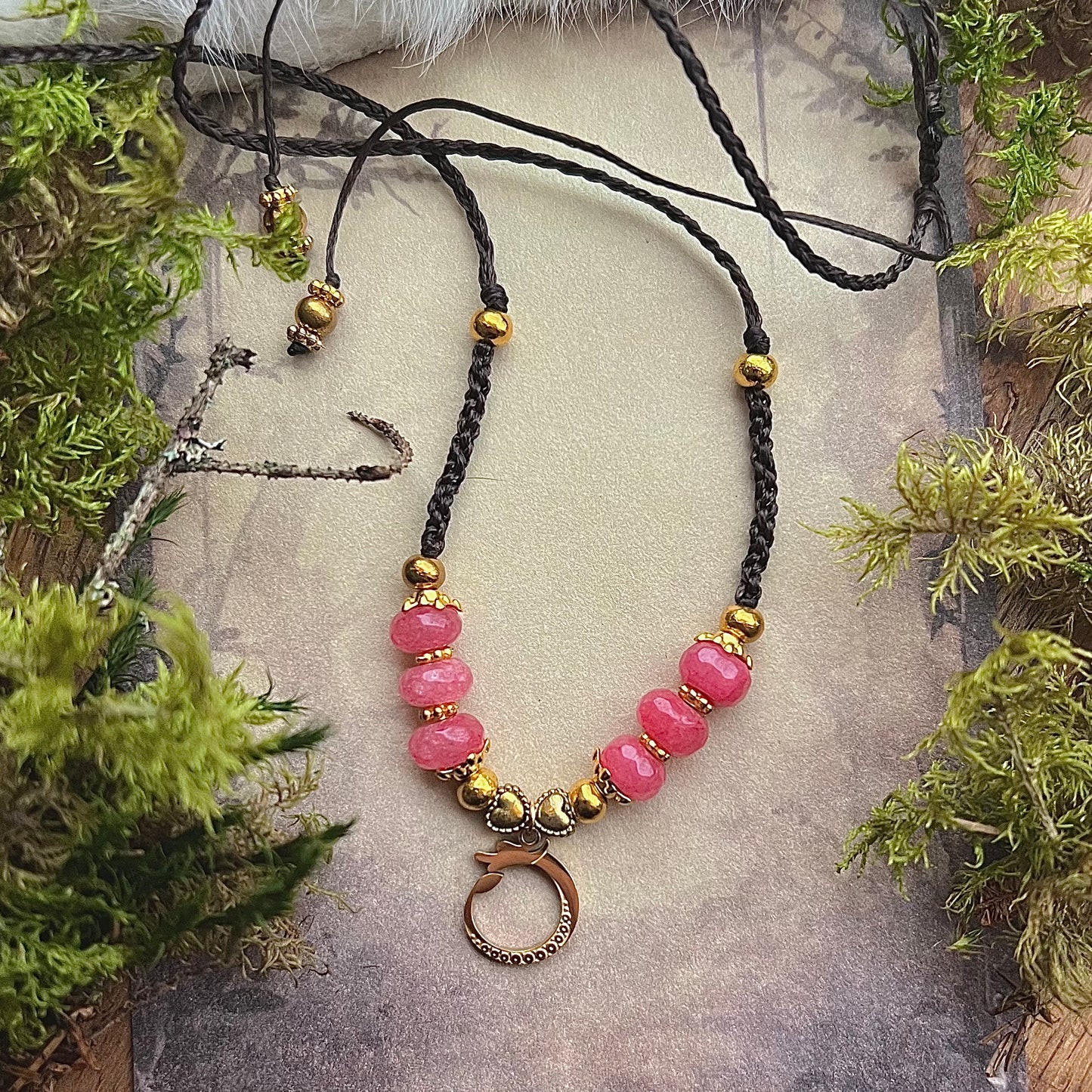 Hand-knotted necklace with faceted jade and dragon pendant