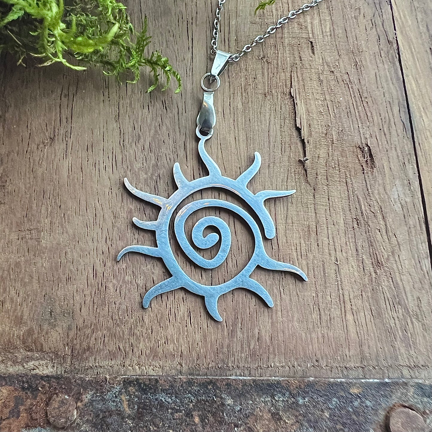 Stainless steel necklace with spiral sun