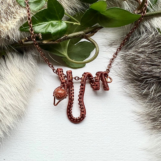 Necklace with copper snake and gold stone