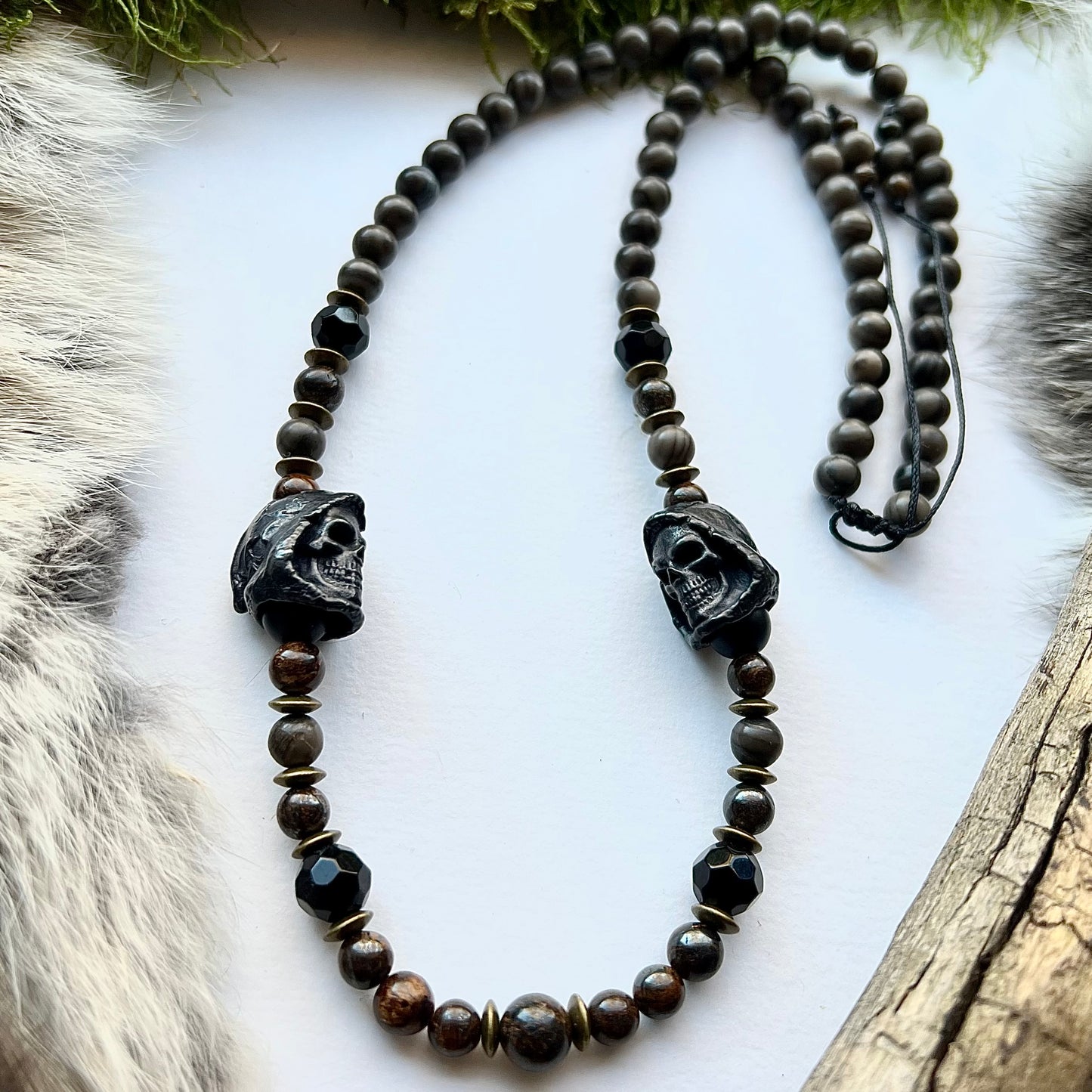 Necklace of wood lace agate, sparkling bronzite and black brass skulls