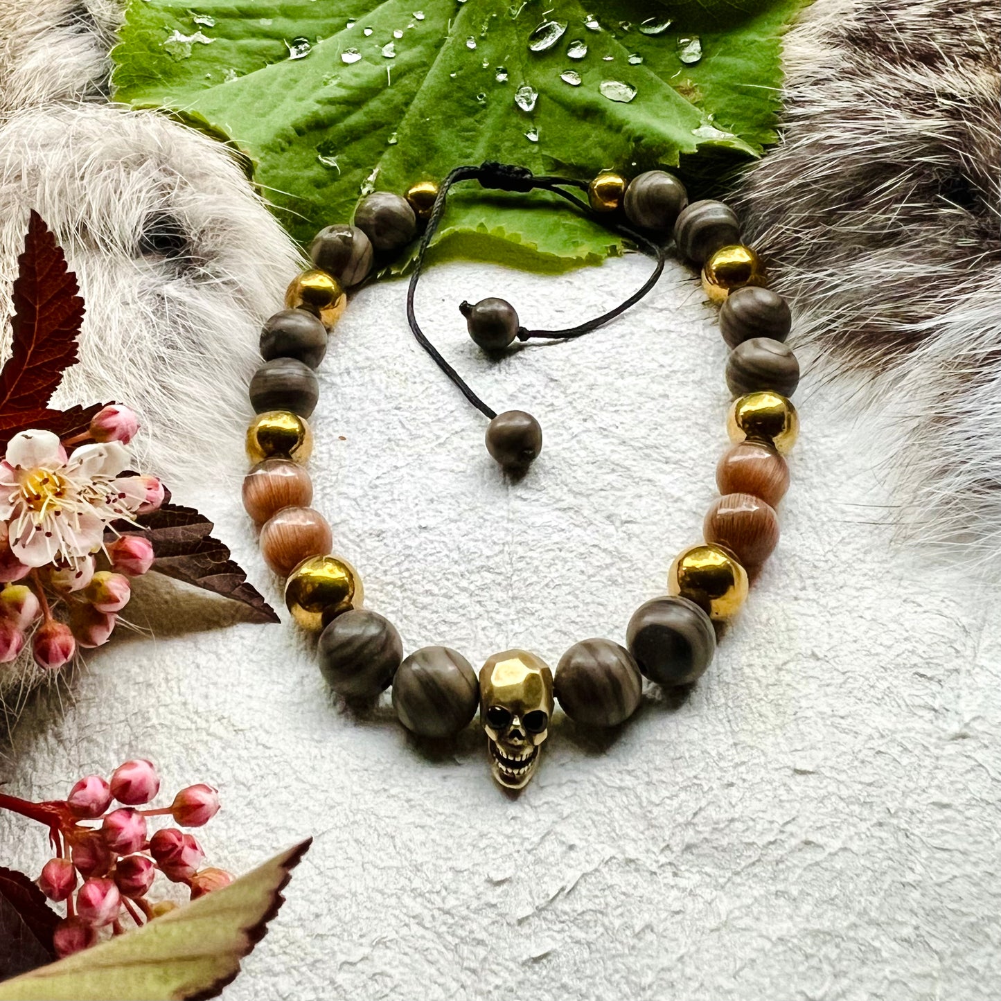 Bracelet with brass skull, petrified tree and cat's eye