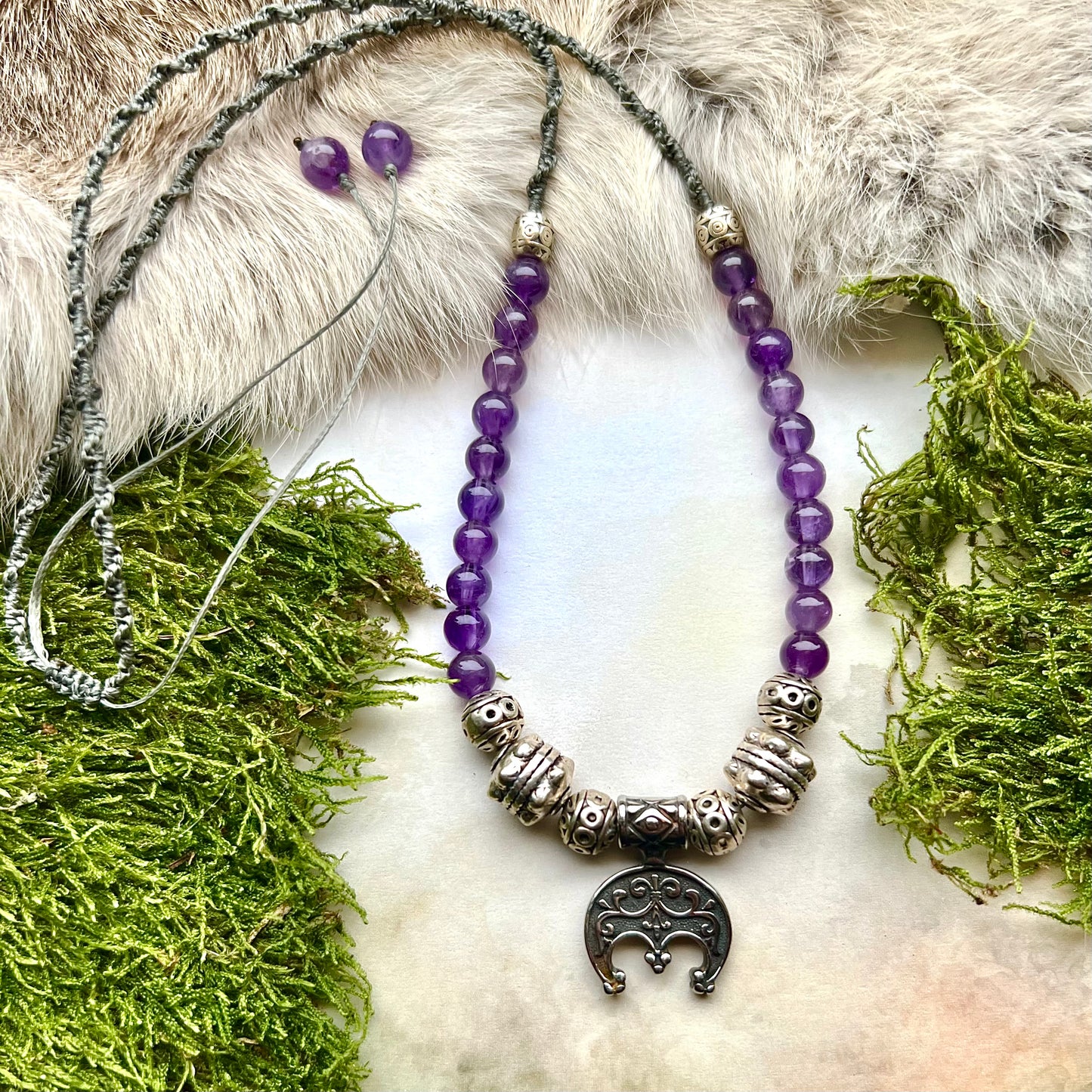 Handknutet halsband med ametister och halvmånehänge i rostfritt stål