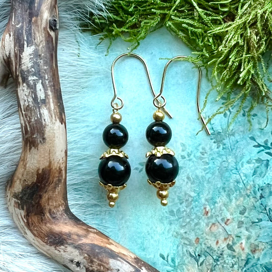 Kristallörhängen med obsidian och guldfärgat stål